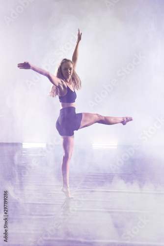 Fototapeta Naklejka Na Ścianę i Meble -  Young modern dancer dancing in the studio. Sport, dancing and urban culture concept. Group of young dancers performing on the stage. Effective performance. beautiful dance. full of energe dancers.