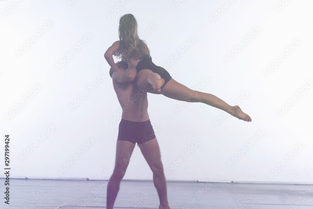Two Young modern dancers dancing in the studio. Sport, dancing and urban culture concept. Group of young dancers performing on the stage. Effective performance. full of energe dancers. Two Young modern dancers dancing in the studio. Sport, dancing and urban culture concept. Group of young dancers performing on the stage. Effective performance. full of energe dancers.