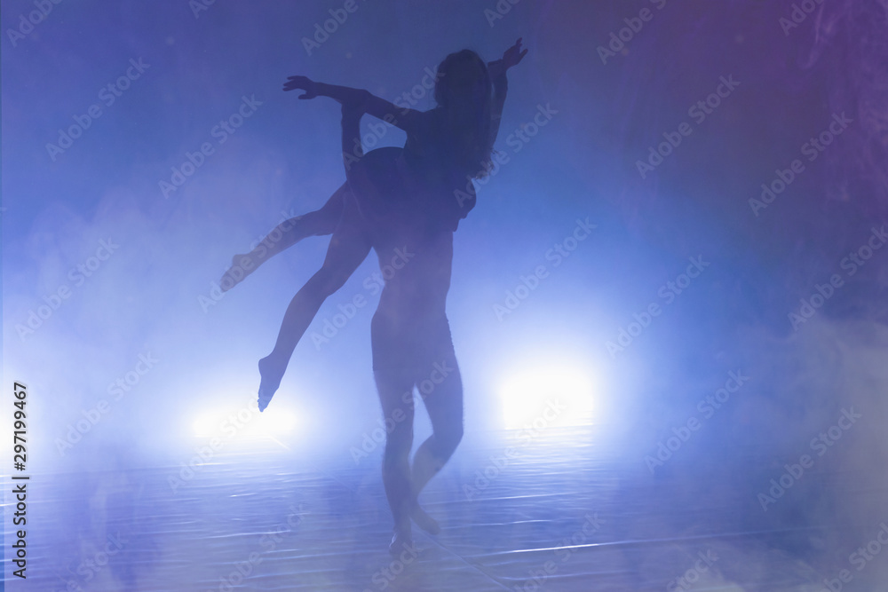 Two Young modern dancers dancing in the studio. Sport, dancing and urban culture concept. Group of young dancers performing on the stage. Effective performance. full of energe dancers.