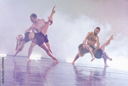 Young modern dancers dancing in the studio. Sport, dancing and urban culture concept. Group of young dancers performing on the stage. Effective performance. beautiful dance. full of energe dancers.