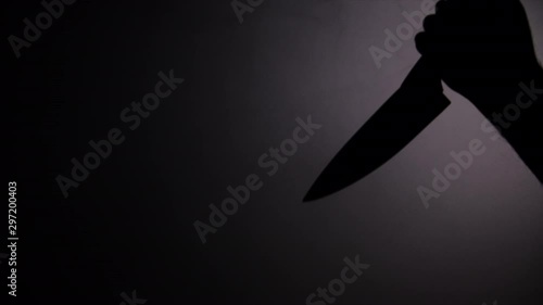 Dark smoke and shadow of killer hand holding a big knife