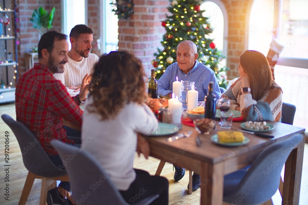 Beautiful family smiling happy and confident. Eating roasted turkey celebrating Christmas at home Beautiful family smiling happy and confident. Eating roasted turkey celebrating Christmas at home