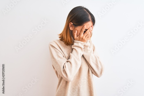 Beautiful redhead woman wearing winter turtleneck sweater over isolated background with sad expression covering face with hands while crying. Depression concept.