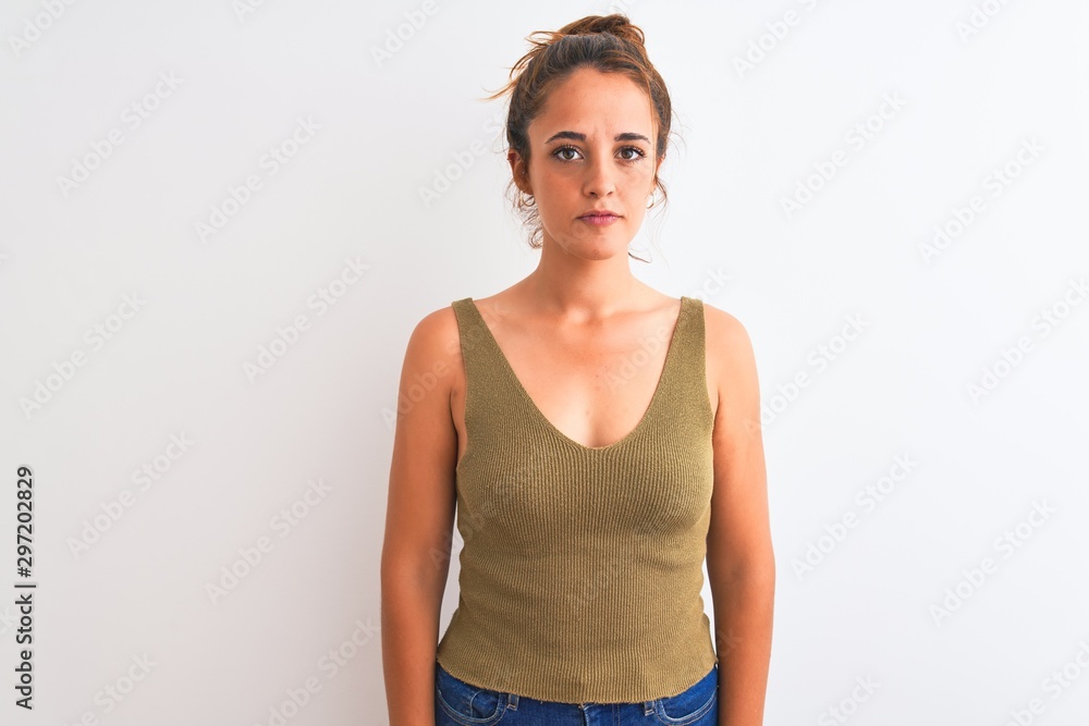Young redhead woman wearing a bun over isolated background Relaxed with serious expression on face. Simple and natural looking at the camera. Young redhead woman wearing a bun over isolated background Relaxed with serious expression on face. Simple and natural looking at the camera.