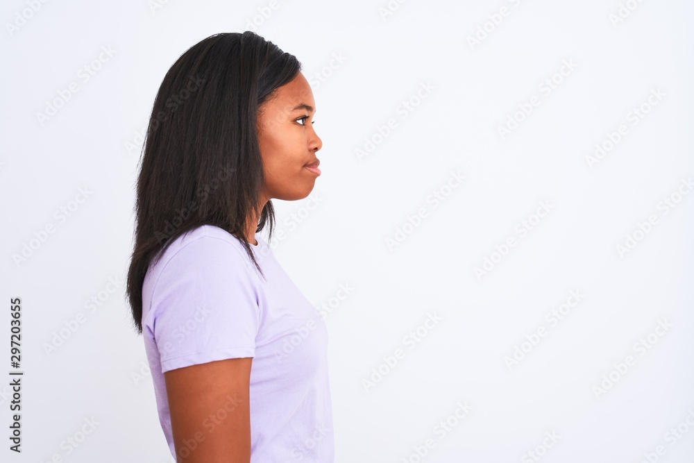 Beautiful young african american woman over isolated background looking to side, relax profile pose with natural face with confident smile. Beautiful young african american woman over isolated background looking to side, relax profile pose with natural face with confident smile.