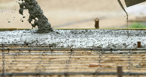 Work industrial concept : Pouring and sweep the wet cement on the floor in process of house building