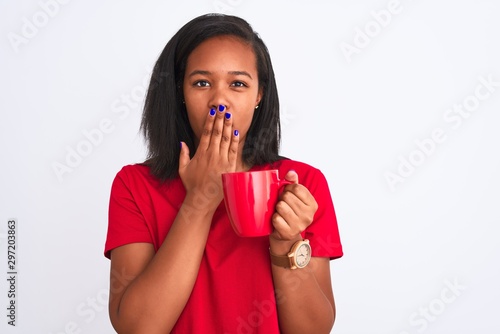 Young african american woman drinking a cup of coffee over isolated background cover mouth with hand shocked with shame for mistake, expression of fear, scared in silence, secret concept