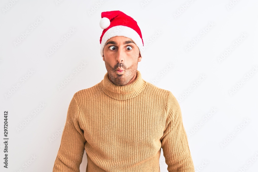 Young handsome man wearing christmas and turtleneck sweater over isolated background making fish face with lips, crazy and comical gesture. Funny expression. Young handsome man wearing christmas and turtleneck sweater over isolated background making fish face with lips, crazy and comical gesture. Funny expression.