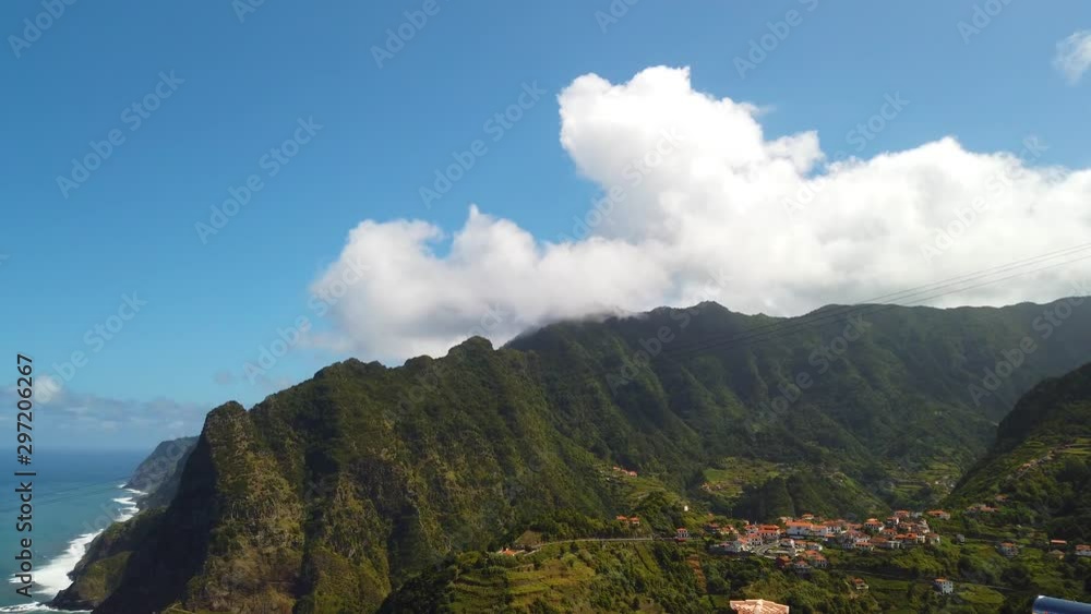 4K video of amazing view of Madeira mountain peaks. Tropical green landscape, buildings in villages are surrounded by green forests of wild nature. 4K video of amazing view of Madeira mountain peaks. Tropical green landscape, buildings in villages are surrounded by green forests of wild nature.