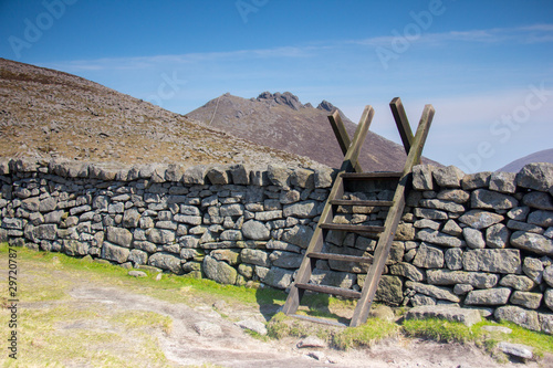 Wooden stile over a dry stone wall in the unique landscape. Mournes moutains, Northern Ireland