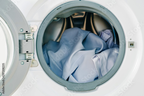 Close up white clothes in washing machine background. Laundry concept.