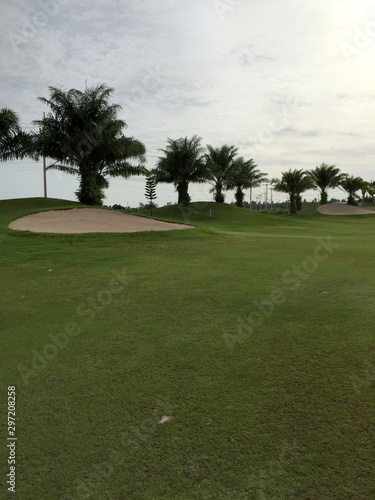 sand and rough green grass from golf ground