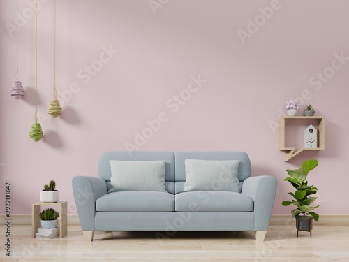 Modern living room interior with sofa and green plants,lamp,table on pink wall background.