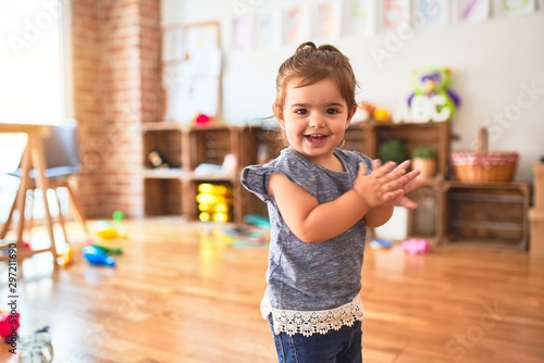 Fototapete Beautiful toddler standing on the floor applauding and smiling at kindergarten