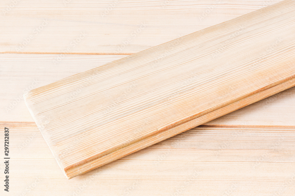 Wooden polished boards with a latch for collecting surfaces. One board lies across the rest. Eco-friendly natural lumber