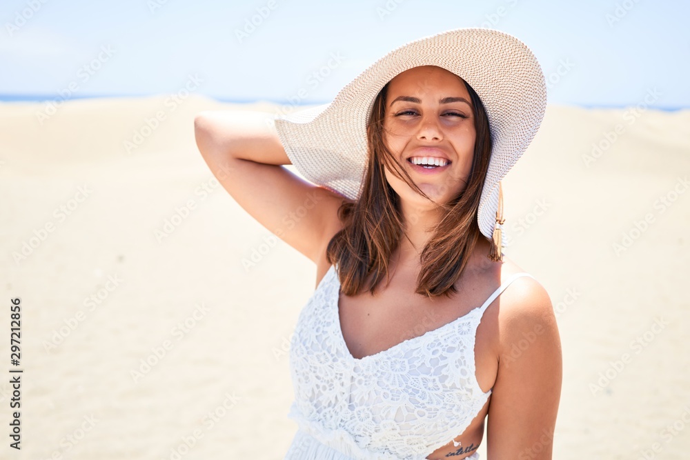 Young beautiful woman smiling happy enjoying summer vacation at maspalomas dunes beach Young beautiful woman smiling happy enjoying summer vacation at maspalomas dunes beach