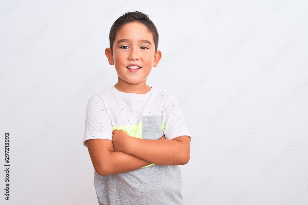Beautiful kid boy wearing casual t-shirt standing over isolated white background happy face smiling with crossed arms looking at the camera. Positive person. Beautiful kid boy wearing casual t-shirt standing over isolated white background happy face smiling with crossed arms looking at the camera. Positive person.