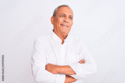 Senior grey-haired man wearing elegant shirt standing over isolated white background smiling looking to the side and staring away thinking. © Krakenimages.com