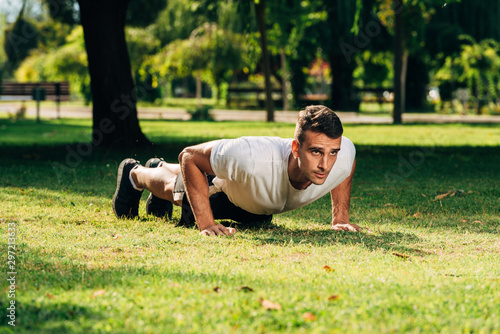 Push up fit man doing arm workout exercising bodyweight exercise pushup outdoor in nature
