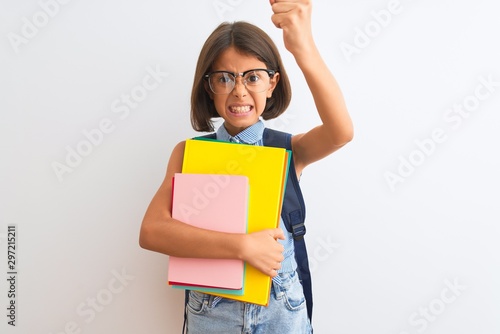 Beautiful student child girl wearing backpack glasses books over isolated white background annoyed and frustrated shouting with anger, crazy and yelling with raised hand, anger concept