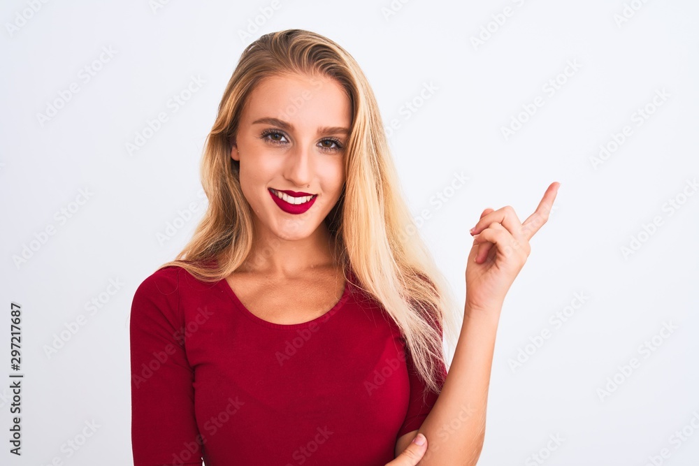 Young beautiful woman wearing red t-shirt standing over isolated white background very happy pointing with hand and finger to the side Young beautiful woman wearing red t-shirt standing over isolated white background very happy pointing with hand and finger to the side