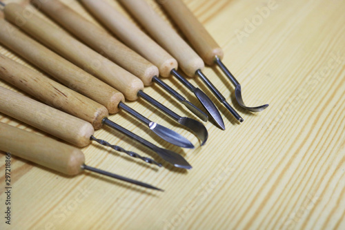 Set of sculpture tools with different shapes for modeling on a wooden desk