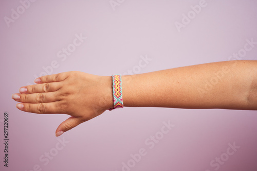 Model arm with beautiful handmade colorful bracelet on wrist