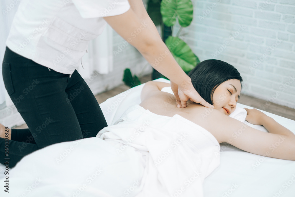 Beautiful young woman lying down on beds massage and spa at asian spa massage and beauty salon center, spa concept, massage concept Beautiful young woman lying down on beds massage and spa at asian spa massage and beauty salon center, spa concept, massage concept