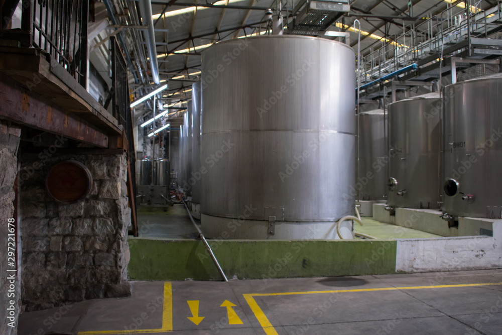 Metal tanks for wine fermentation inside a winery Metal tanks for wine fermentation inside a winery