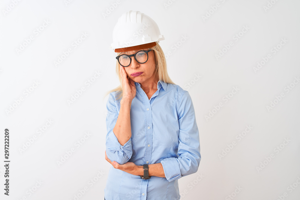 Middle age architect woman wearing glasses and helmet over isolated white background thinking looking tired and bored with depression problems with crossed arms. Middle age architect woman wearing glasses and helmet over isolated white background thinking looking tired and bored with depression problems with crossed arms.