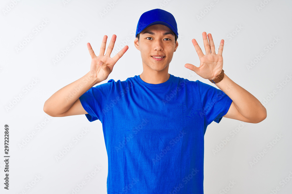 Chinese deliveryman wearing blue t-shirt and cap standing over isolated white background showing and pointing up with fingers number nine while smiling confident and happy. Chinese deliveryman wearing blue t-shirt and cap standing over isolated white background showing and pointing up with fingers number nine while smiling confident and happy.