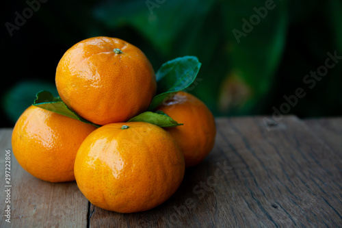 Fresh oranges, colored balls and green leaves, beautiful skin, laid on the old wooden floor..