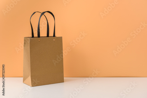 mockup of blank craft package or Brown paper shopping bag with handles