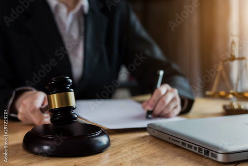 Lawyer office. gavel of Justice with scales and lawyer working on a laptop. Legal law, advice and justice concept.