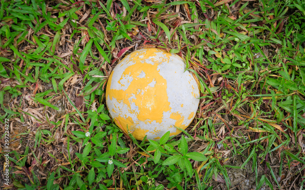 concrete earth ball figure on grass closeup view