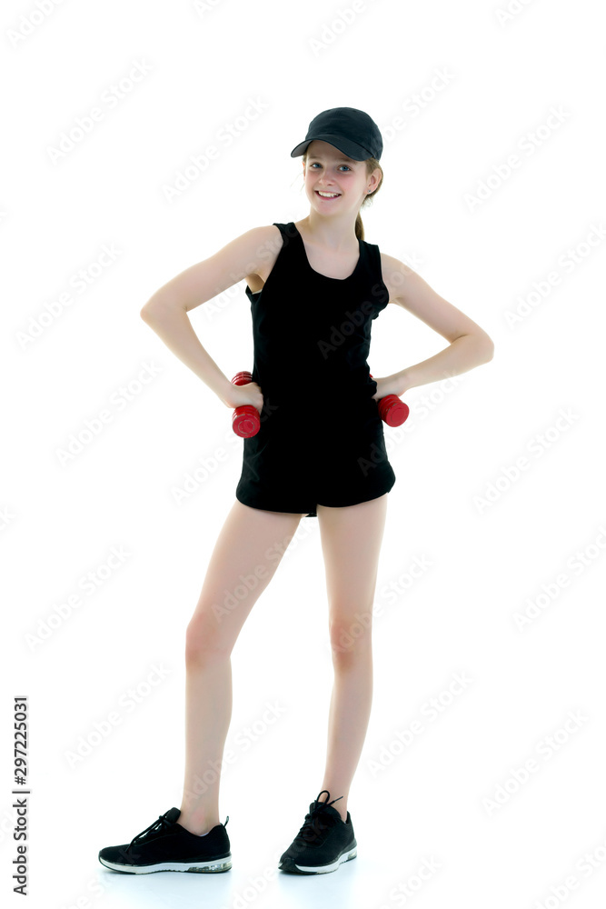 Fototapeta premium Little girl doing exercises with dumbbells.