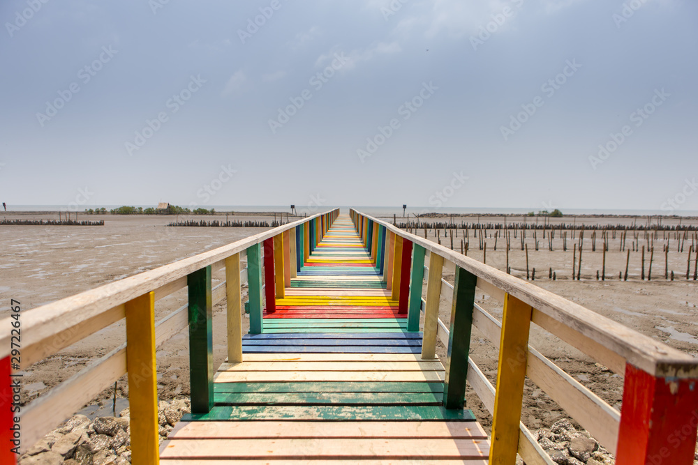 Colorful wooden bridges stretching from the shores of Samut Sakhon coast.