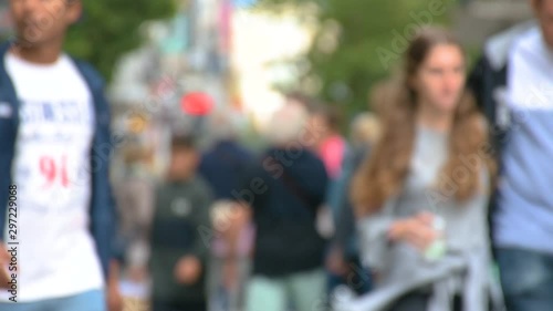 Defocused commuters walking to work or shopping, footage of blurred unrecognizable people, busy city life