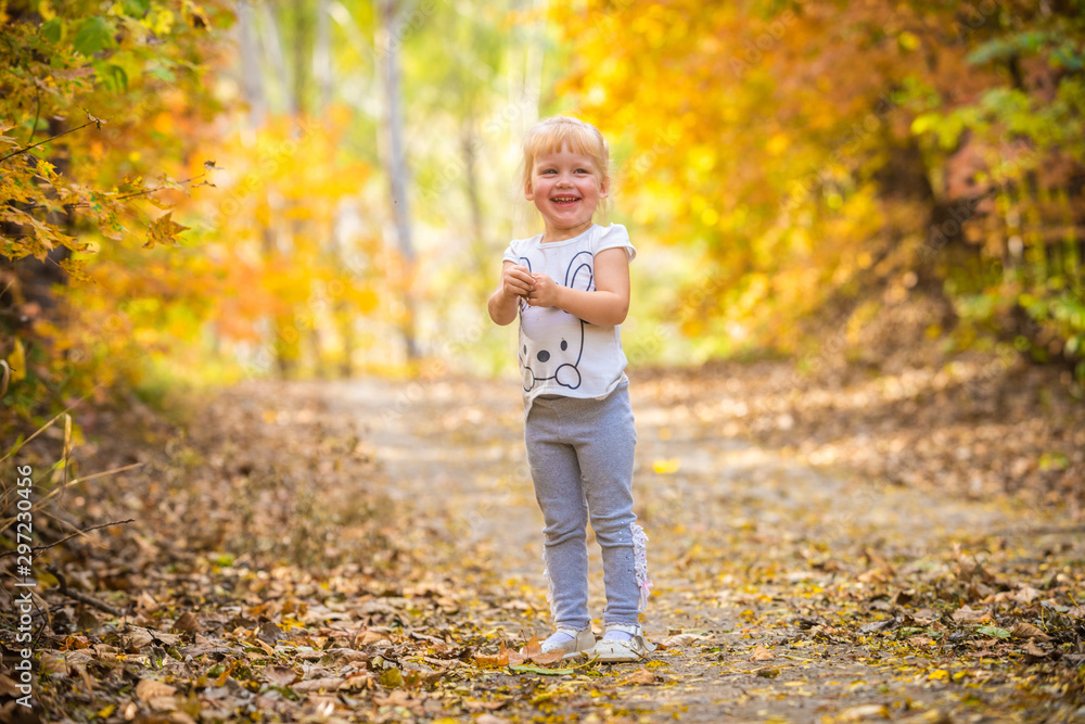 happy little child, baby girl laughing and playing in the autumn on the nature walk outdoors happy little child, baby girl laughing and playing in the autumn on the nature walk outdoors