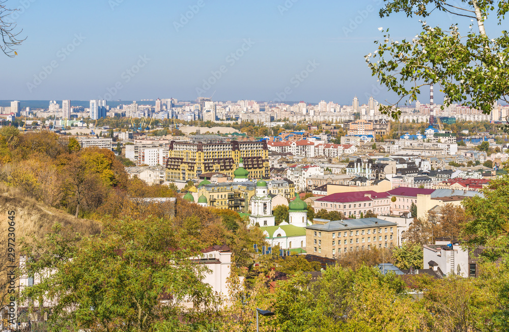 View of the multi-colored roofs of new apartment buildings on Vozdvizhenka in a new residential area in the ancient historic district of Podol, Kiev, Ukraine. In the background is Obolon.