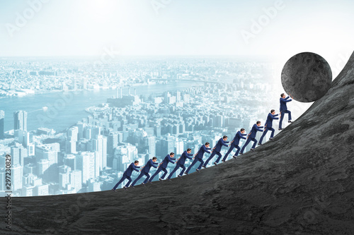 Canvas Print Team of people pushing stone uphill