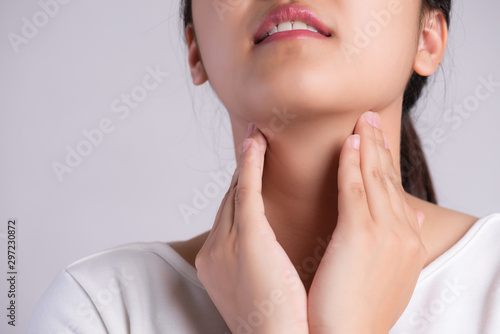 Sore Throat. Closeup Of Beautiful Young Woman Hand Touching Her Ill Neck. Healthcare and medical concept.