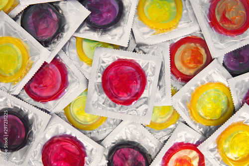 Colorful condom on background. large number of condoms. concept of safe sex. lots of rubber condoms. bunch of objects photo