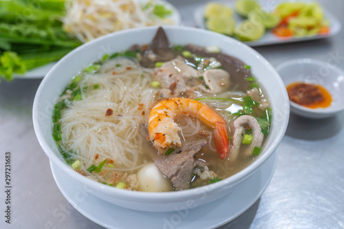 Tasty Vietnamese rice noodle soup served with green vegetables