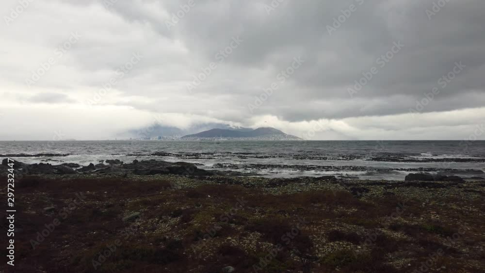 Storm clouds over Cape Town seen from shore of Robben Island Storm clouds over Cape Town seen from shore of Robben Island