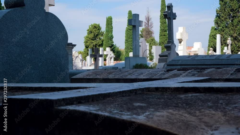 Quiet cemetery, handheld graves with
close-up grave detail, daylight. Quiet cemetery, handheld graves with
close-up grave detail, daylight.