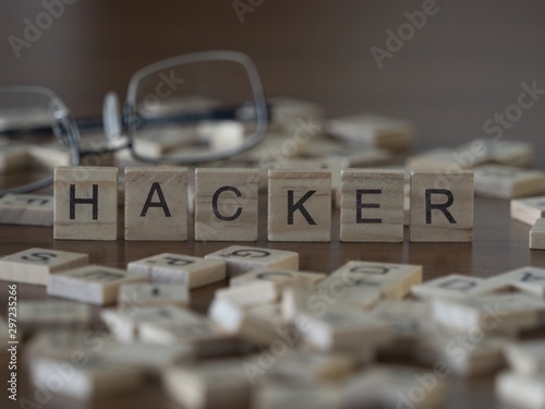 The concept of Hacker represented by wooden letter tiles photo