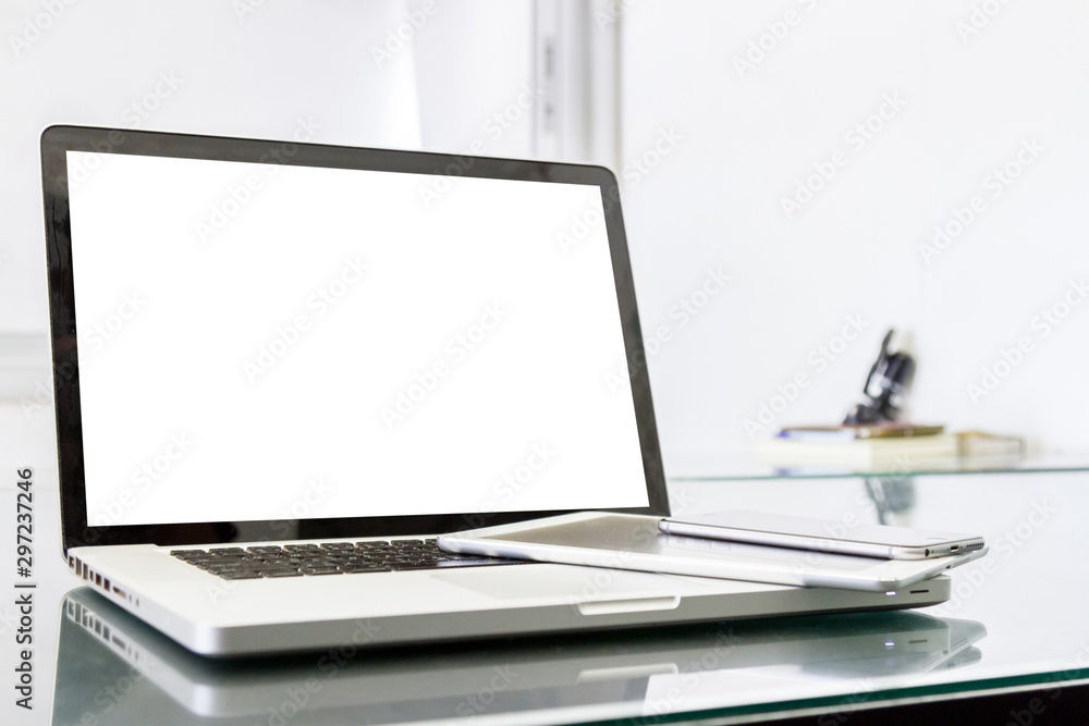 laptop computer with blank white screen and digital tablet on table laptop computer with blank white screen and digital tablet on table