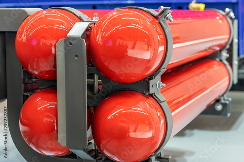 red gas cylinders with propane mounted on a car with gas equipment