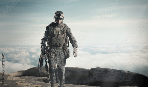 Fotografia, Obraz Soldier with a rifle. Steps against clouds.
